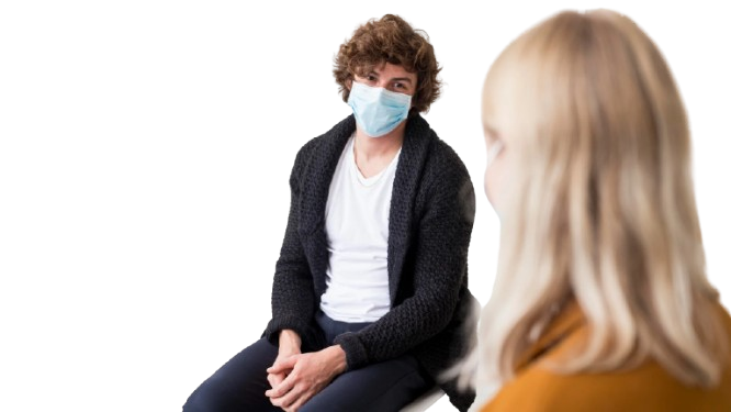 A young man in a mask talking to a woman about mental health