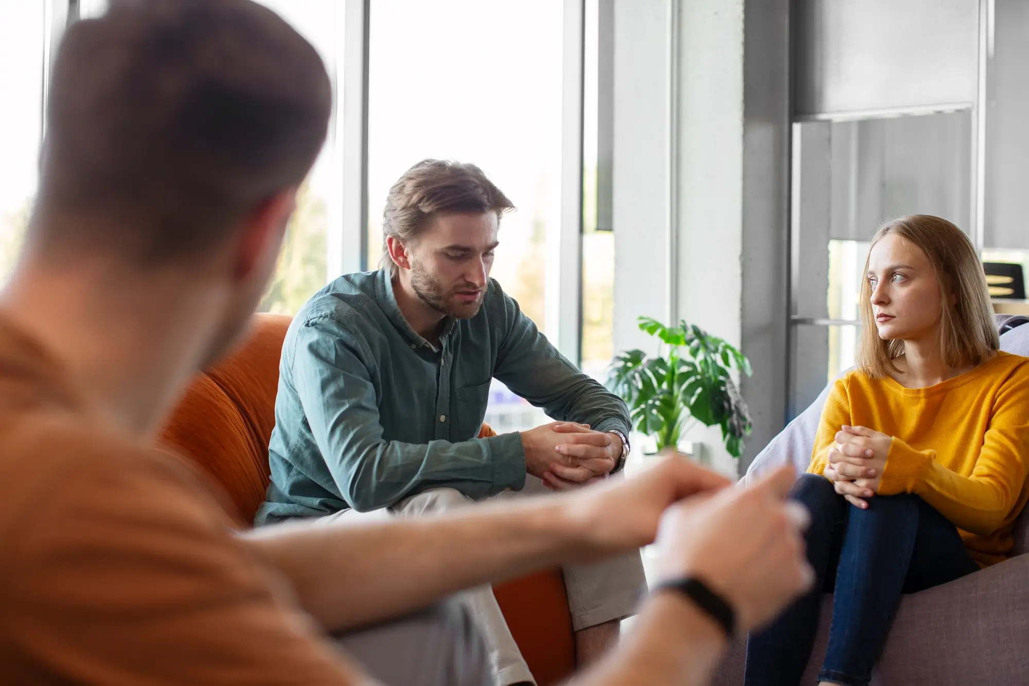 A woman and man meeting with a professional about using Medicaid