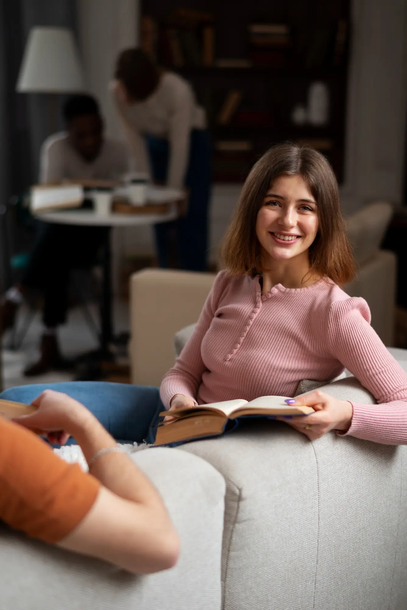 Woman holding a book smiling because she knows she has the proper mental health care