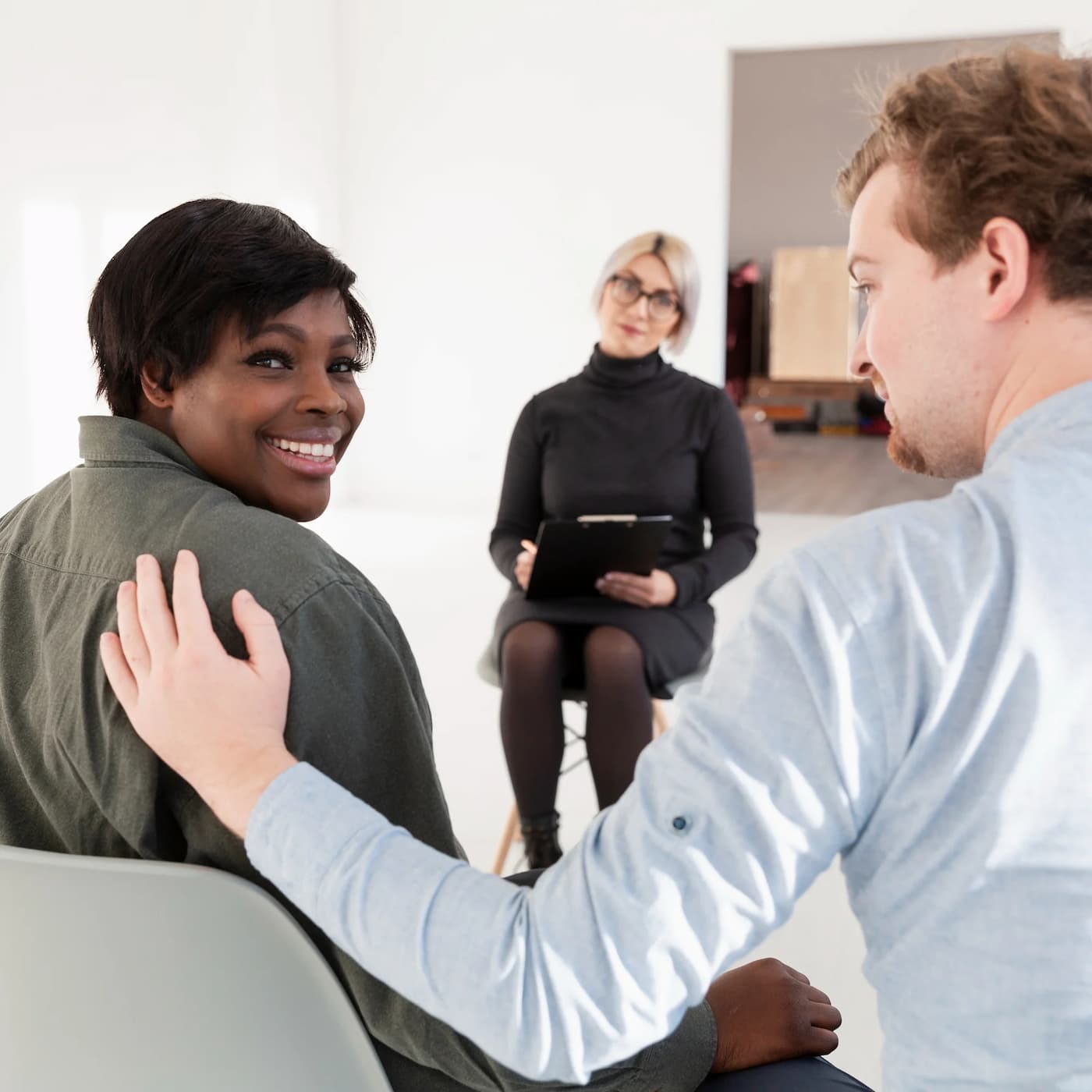 Woman smiling in a meeting about mental health support