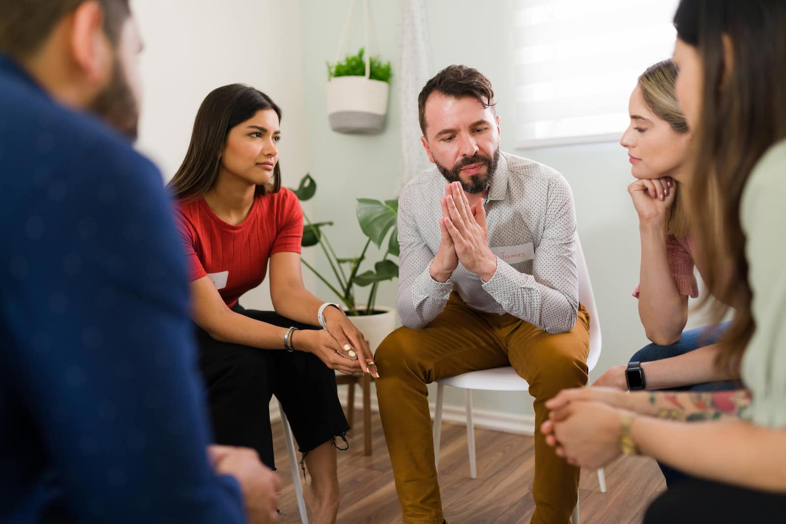 A group of people meeting about mental health support services