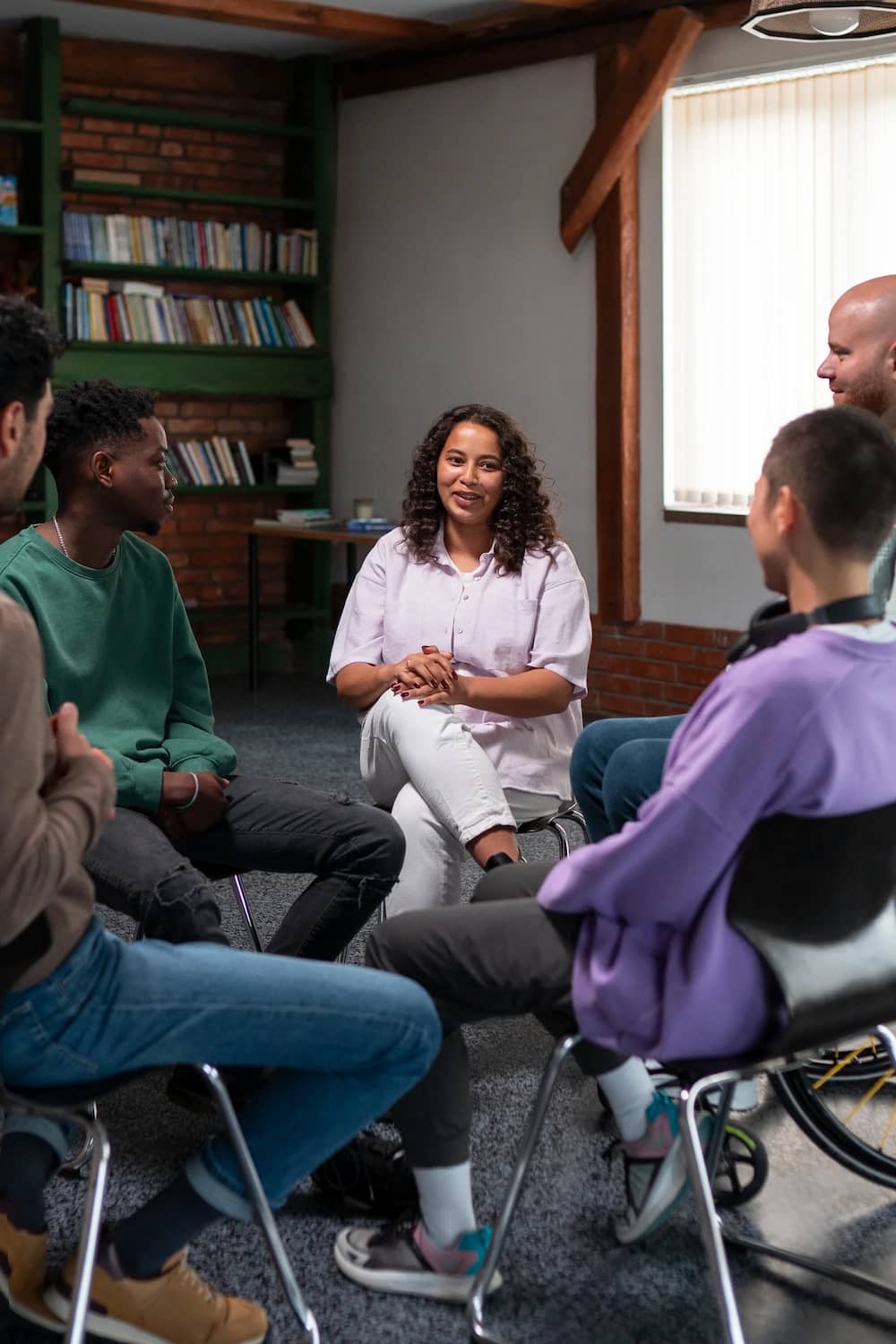 A woman speaks at a mental health therapy session