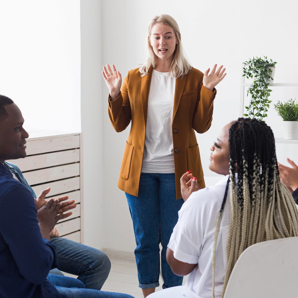 Woman speaking at a meeting about mental health care